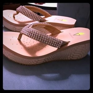 Volatile wedges in winery gold.  Size 9.